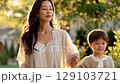 A shining time for raising children: Mother and child holding hands in the sunset 129103721