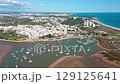 Beautiful aerial view of alvor, portugal, showcasing the ria de alvor estuary, the atlantic ocean, the marina, white buildings, and green vegetation. Aerial view praia de Alvor 129125641