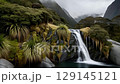 Deep gorge with cascading waterfalls and lush vegetation 129145121