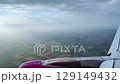 Aerial View of Airplane Flying Over Vast Fields at Dawn 129149432