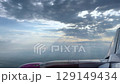 Majestic View of Airplane Wing Above Scenic Clouds in Flight 129149434