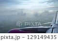Serene Aerial Journey: View from Airplane Flying Above Clouds 129149435