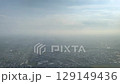 Aerial Cityscape View: Hazy Metropolis Under Sunlit Sky Captivates 129149436