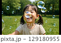 Girl and soap bubbles 129180955