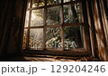 Dusty old window frame with sunlight, view of green nature outside. Rustic and antique feel. 129204246