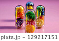 Creative capsules filled with colorful fruits and vegetables on a pink background display healthy eating concepts 129217151