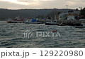 Sea bay at evening with boats swaying on waves. Cityscape on Bosphorus, Istanbul coastline. Marine life, travel concept 129220980