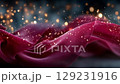Flowing red fabric with sparkling bokeh lights creates an enchanting atmosphere, showcasing the beauty of texture and movement in a captivating visual display 129231916