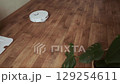 Robot helper mops the floor creating a clean and fresh atmosphere at home for comfortable living 129254611