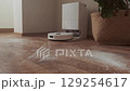 Robot vacuum receives cleaning task from owner and starts working leaving the charging station for daily cleaning. 129254617