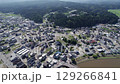 Drone footage of Suzu City in Noto, Japan. A mix of residential neighborhoods, small commercial buildings, and dense forested hills captures the harmony between town and nature in this rural area. 129266841