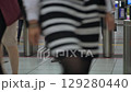 People hurrying out of the station ticket gates 129280440