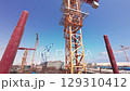 Tower cranes operating at large construction site 129310412