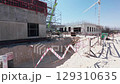 Construction site with foundation trench and concrete buildings 129310635