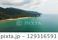 Aerial panorama of Ko Lanta island in Thailand with white sand beach, turquoise sea, rocky cliffs, small boats, and lush tropical hills - an exotic and popular holiday destination. 129316591