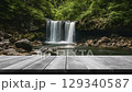 Creative outdoor concept. Empty wooden bridge in focus with blur defocused waterfall flowing stream cascade river landscape background. Template presentation. wallpaper banner clip mov 4K HD motion	 129340587