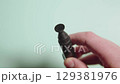 Photographer's hand showing specialized pen for cleaning lenses 129381976