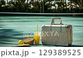 A silver suitcase with a pickleball paddle and wicker baskets standing at a tennis court. 129389525