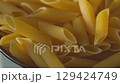Dry Penne Pasta in Ceramic Bowl on Kitchen Counter Tilt-Up Shot 129424749