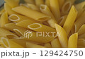 Dry Penne Pasta in Ceramic Bowl on Kitchen Counter Tilt-Up Shot 129424750