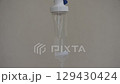 saline solution dropping and flowing to rubber tube on white background 129430424
