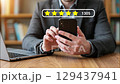 User satisfaction concept with a five-star rating and positive review score on a mobile device 129437941