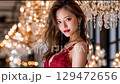 Beautiful nightlife woman with a luxurious chandelier in the background 129472656