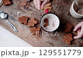 Gingerbread man being dipped in cocoa, close-up. Preparing for Christmas. 129551779