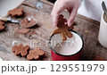 Gingerbread man being dipped in cocoa, close-up. Preparing for Christmas. 129551979