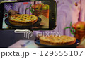 Capturing homemade dessert preparation: filming delicious pie with smartphone 129555107