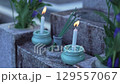Incense and candles offered at the grave 129557067