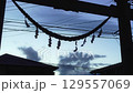 Paper streamers swaying in the wind at a shrine in the evening 129557069