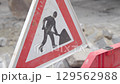 Sign Indicating that Construction Work is Ahead in Urban Area Setting 129562988