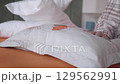 young woman Making a bed at early morning  129562991