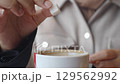A Sugar Cube Delicately Being Added to a Warm Cup of Coffee, Enhancing the Experience 129562992