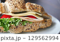 Sandwich With Smoked Chicken Salami on table  129562994