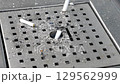 The collection of cigarette butts found in the outdoor ashtray on a public street 129562999