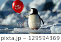 penguin releasing a red balloon with the inscription Happy B-day 129594369