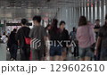 Busy Crowd of People Walking in Urban Corridor 129602610