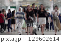 Busy Pedestrian Bridge in Modern City: People Walking and Enjoying Urban Life 129602614