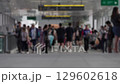 Busy Urban Scene of Unrecognizable Crowds in a Modern Transit Terminal 129602618