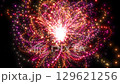 A loop background of light particles that draw an arc and gather in the center, red 129621256