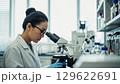 研究室で顕微鏡を使う女性科学者 129622691