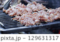 chicken fillet fried on barbecue grill for restaurant cooking, slow motion 129631317