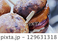 Baked crispy burgers with beef patty, cheese, vegetables and bun, slow motion, close-up 129631318