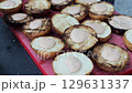 Lots of burger buns with sauce on the table, slow motion 129631337