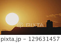Big sun and a view of the rooftops of the city in real time 129631457