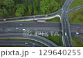 Aerial view flying over of loaded cars with traffic jam at rush hour on highway with bridge 129640255
