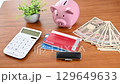 Bankbook, seal, piggy bank and stack of Japanese yen 129649633