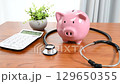 Image of medical expenses using a stethoscope and a piggy bank 129650355